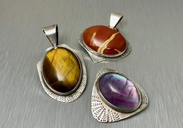 Image of three jeweled pendants.