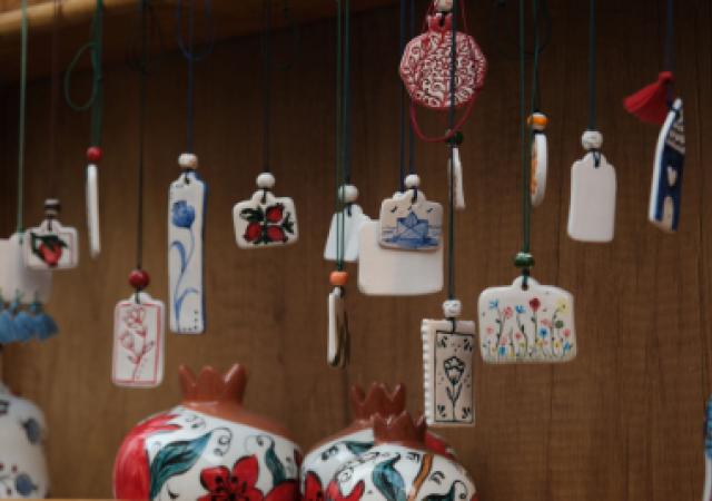 Photo of several handcrafted ceramic pendants hanging.