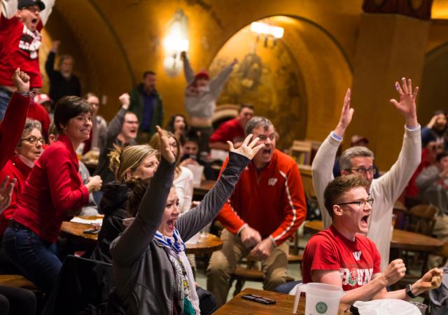Individuals cheering at a Game Watch event