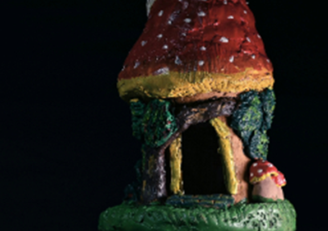 Photo of a mushroom fairy house made from clay.