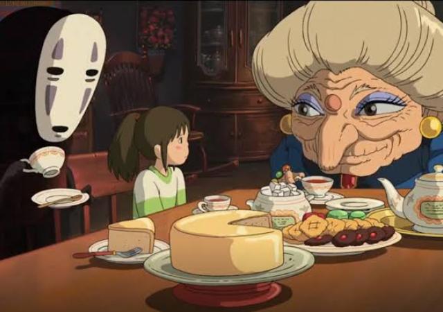 three animated characters seated at a table covered with food