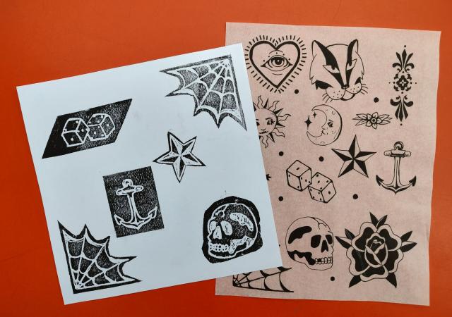 Photo of tattoo drawings on paper.