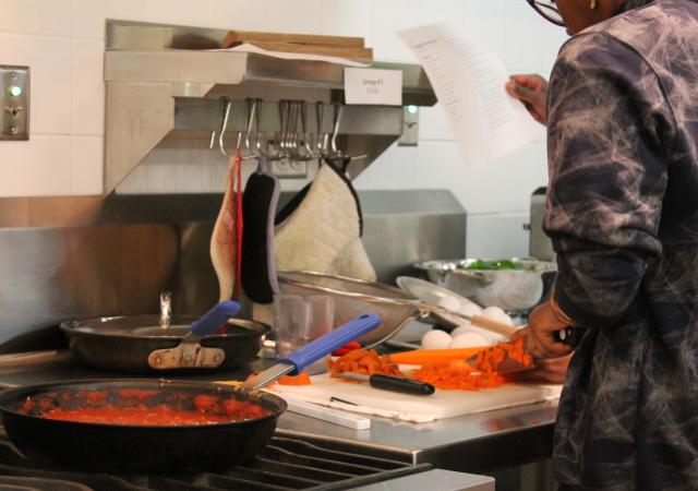 Participant preparing ingredients &amp; making sauce for pizza