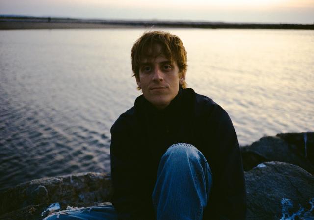 Renny Conti sitting by a body of water