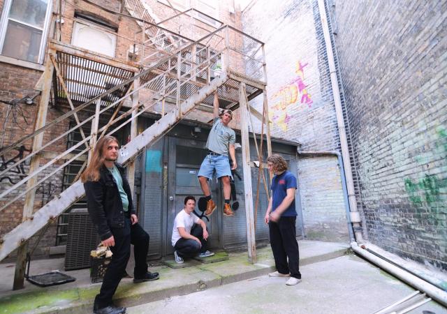 Ripcord band posing around a stairwell.