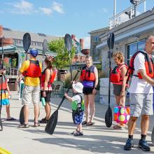 Families preparing to paddle on the lake