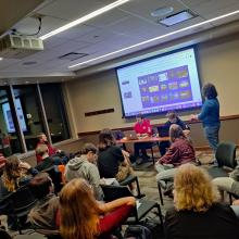 A group of people looking at a screen