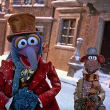 Still from Muppets Christmas Carol, Gonzo and Rizzo stand in a snowy street.