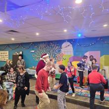 GiGi's Holiday party participants and volunteers interacting at and enjoying the party