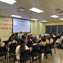 students watching a presentation lead by wud volunteer action presdient