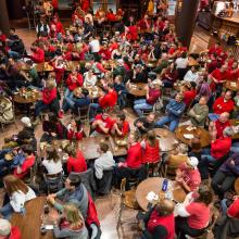 Individuals watching a sports game in the Sett
