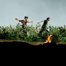 Poster from film Monster (2023), two boys run through a field.
