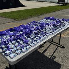 table filled with medals for completing dash for down syndrome race