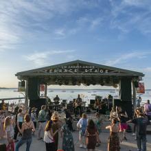 Photo of the memorial union terrace stage with people dancing. 