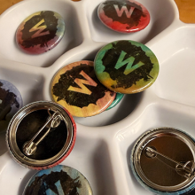 Photo of a collection of buttons with the Wheelhouse Studios logo.