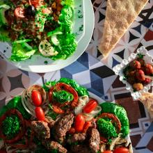 Plates of food with salad, morrocan grill, and tafernout bread