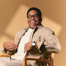 Photo of Isaiah J. Thompson sitting in front of a tan background.