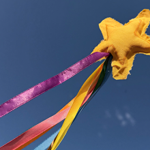 Image of a Pride Magic Wand with a star at the top with colorful ribbon.