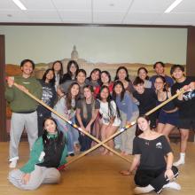 FASO Tinikling group posing with bamboo sticks
