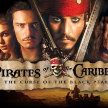 banner reading "Pirates of the Caribbean-The Curse of the Black Pearl" with four faces above it