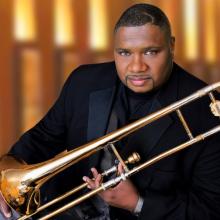 Wycliffe Gordon holding a trombone. 