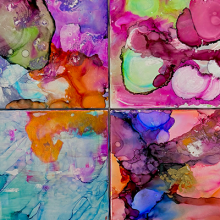 Photo of four different colored paintings. 