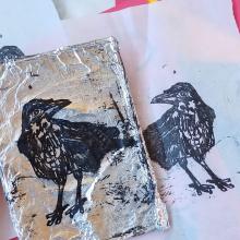 Photo of an art project using tin foil and prints. 