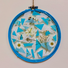 Photo of a suncatcher with pressed flowers inside. 