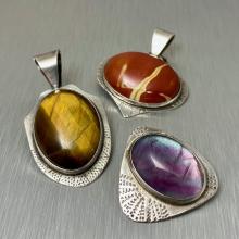 Image of three jeweled pendants. 