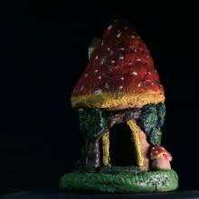 Photo of a mushroom fairy house made from clay. 