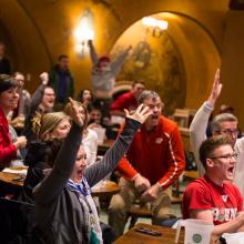 Individuals cheering at a Game Watch event