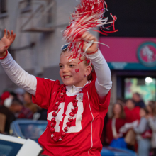 Mini-Marshal Adalyn Howe waves to the crowd lining State Street during the University of Wisconsin-Madison’s Homecoming Parade on Oct. 25, 2024.