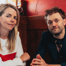 Aoife O'Donovan and Chris Thile sitting at a table.