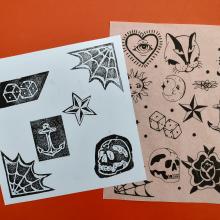 Photo of tattoo drawings on paper.