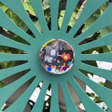 Photo of a lid collage against a sunburst chair.