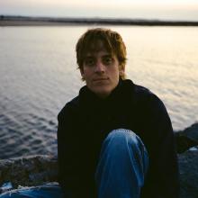 Renny Conti sitting by a body of water