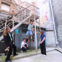 Ripcord band posing around a stairwell.