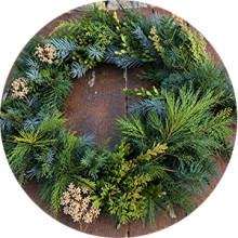 Photo of a crafted green wreath with twigs.